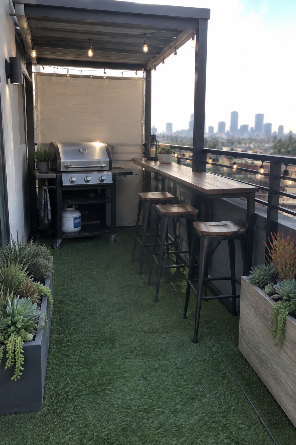 A compact balcony patio has a grill at one end and a long wooden bar counter with stools along the railing.